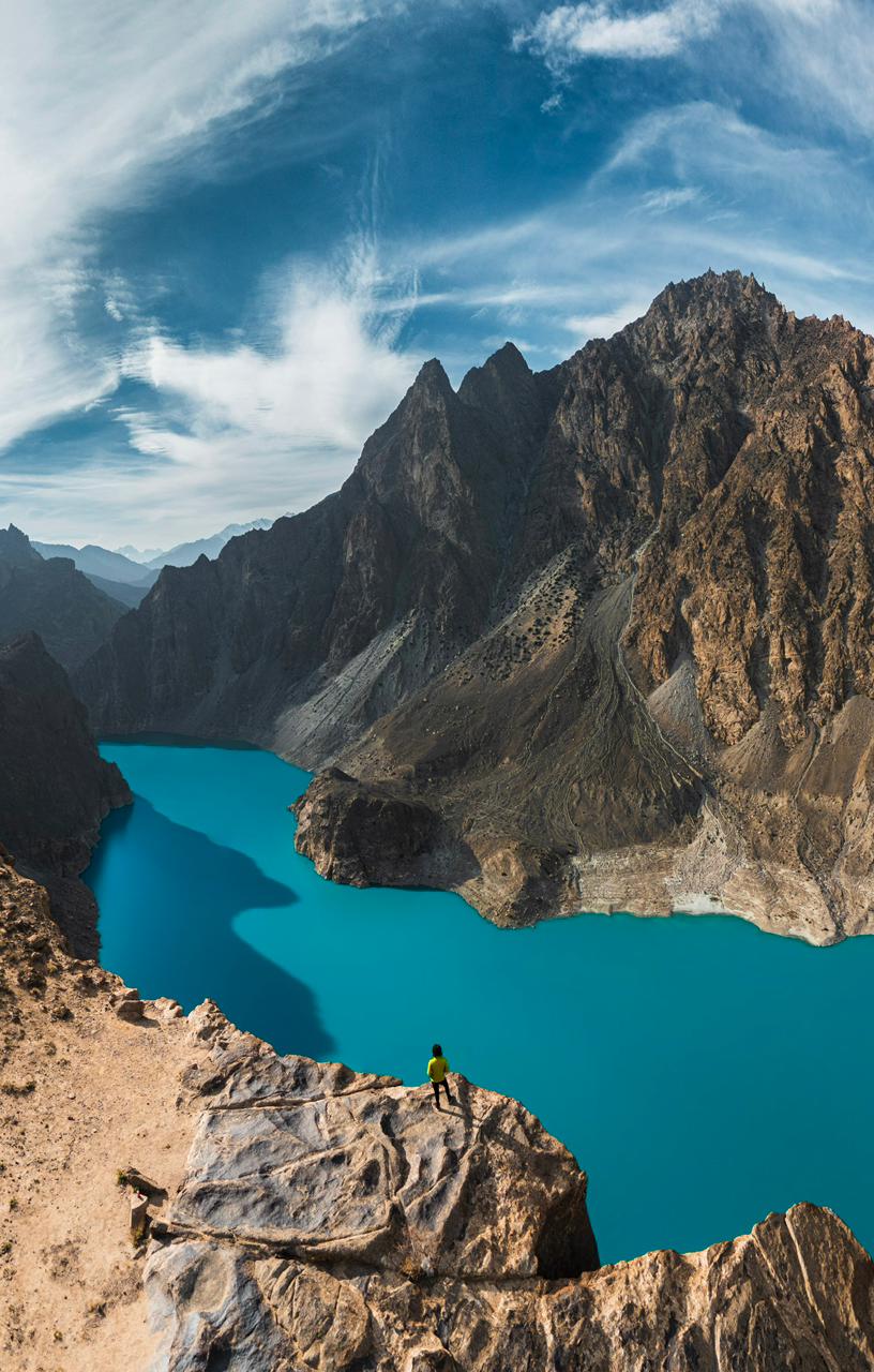 Clear green waters of Lower Kachura Lake surrounded by dense pine and apple orchards