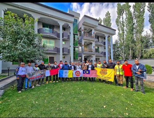 Group of touring guests with the staff on the lawn at Arcadian Resort Skardu